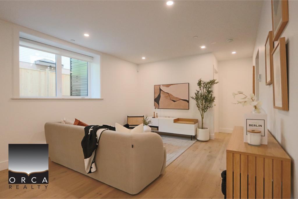 Modern living room with minimalist design, featuring a beige sofa, wooden accents, and contemporary artwork, creating a cozy and stylish space.