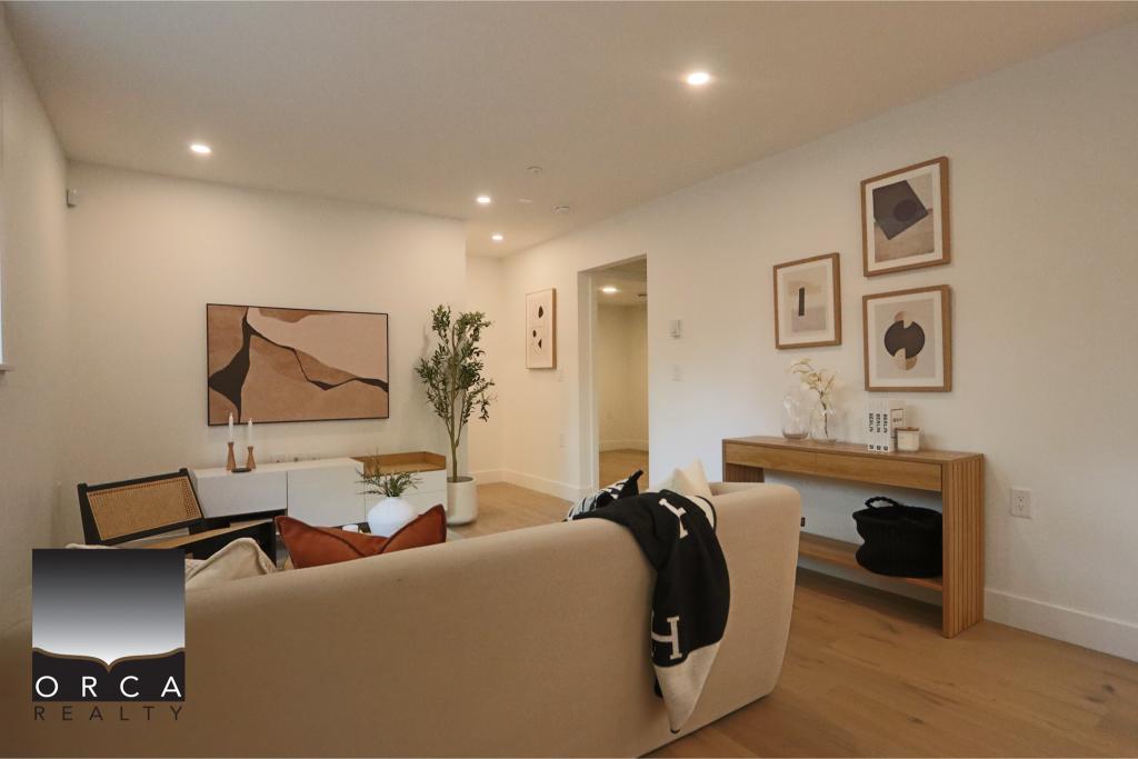 Spacious and stylish living room featuring contemporary furniture, abstract art, and natural lighting, perfect for modern homebuyers seeking comfort and elegance.
