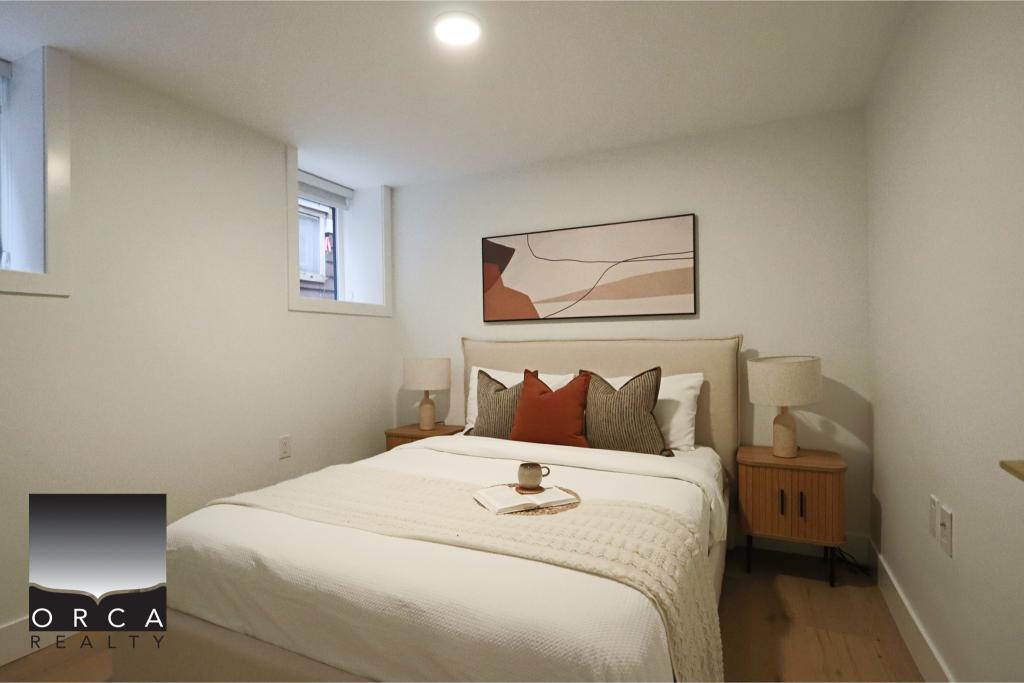 Cozy modern bedroom featuring a comfortable bed, neutral tones, and minimalist decor, ideal for a peaceful living space in Victoria, BC.