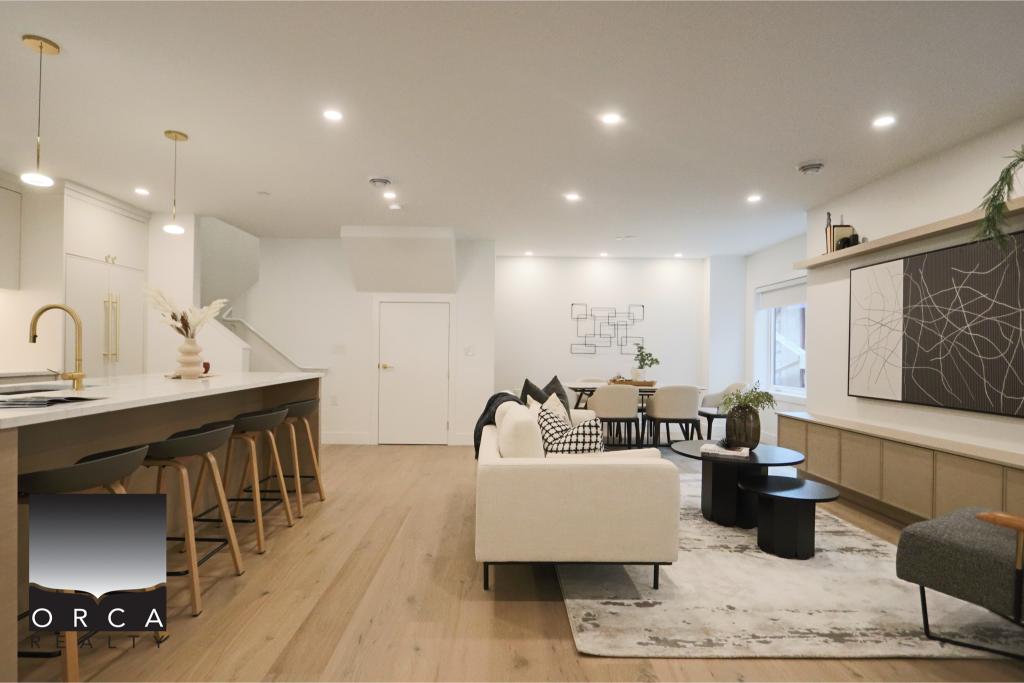 Bright, spacious open-concept living room and kitchen with modern decor, white cabinetry, and natural light, perfect for contemporary Vancouver-area homes.