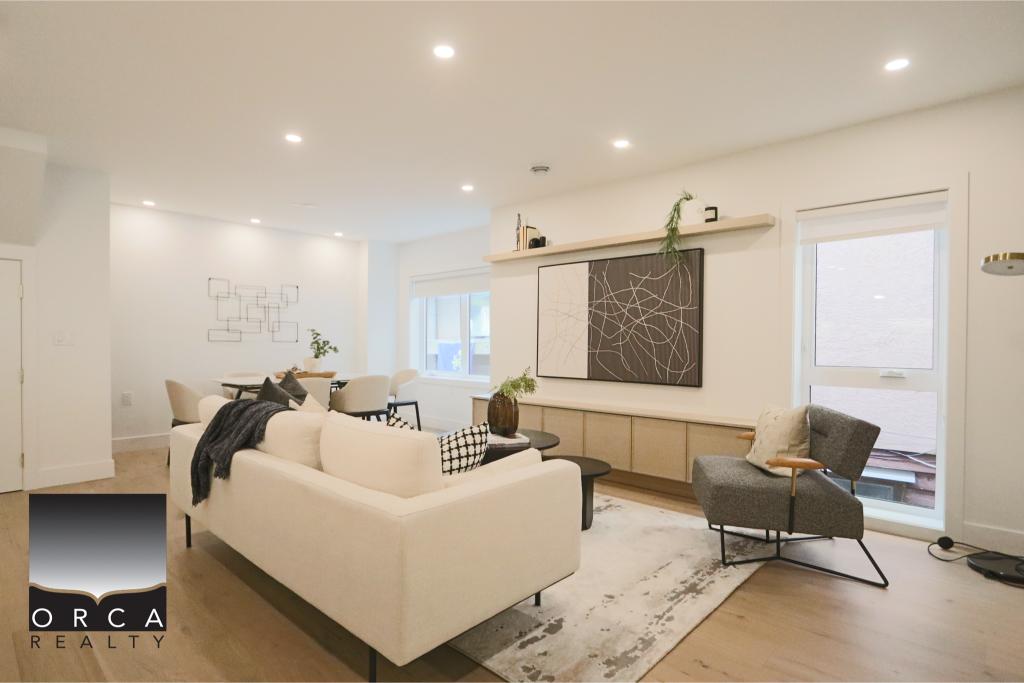 Bright and spacious living room featuring contemporary furniture and large windows for natural light. Perfect for showcasing stylish interior design and home comfort.