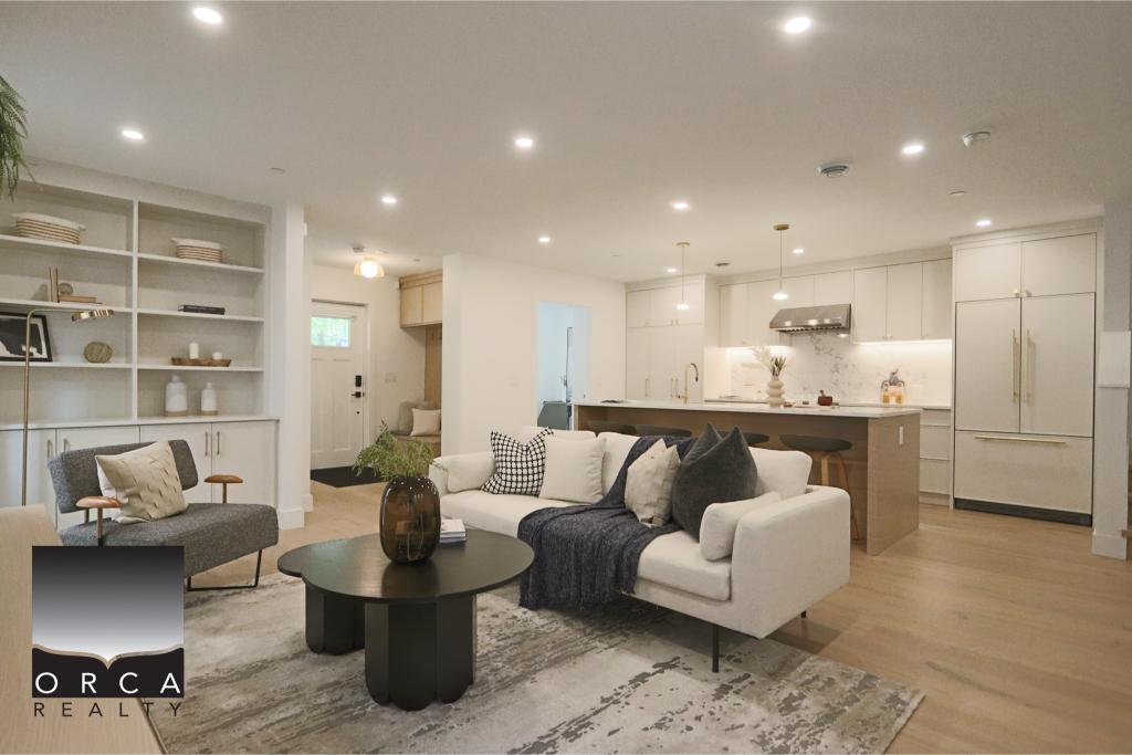Bright, spacious open-concept living room and kitchen in a modern Vancouver home, featuring contemporary furniture, hardwood floors, and stylish decor.