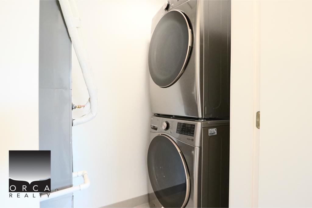 Stacked washer and dryer in a small laundry space, ideal for efficient home cleaning solutions.