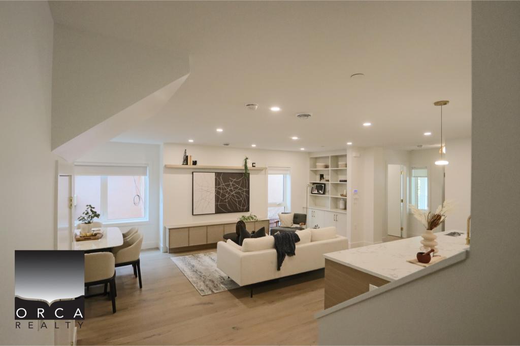 Spacious open-concept living room featuring contemporary furniture, large windows, and elegant decor, ideal for modern homes and real estate listings in Victoria, BC.