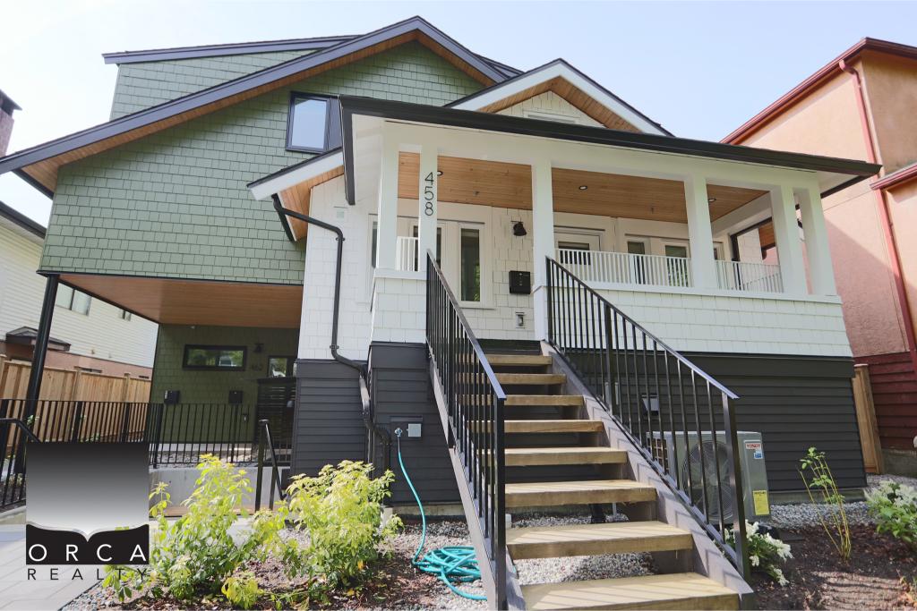 Beautiful modern craftsman-style house with a spacious front porch, black railing, and vibrant exterior colors, located in a residential neighborhood.