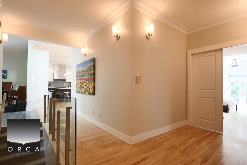 Bright and spacious interior of a home listed by Orca Realty Inc. showcasing clean design, hardwood floors, and natural light. Perfect for families or individuals seeking a comfortable living environm.