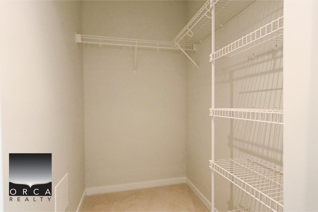 Interior view of a walk-in closet with wire shelving in a Coquitlam property listed by Orca Realty Inc.