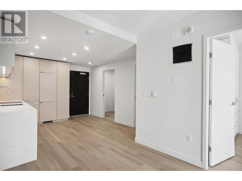 Spacious and modern interior of a condo at 502-239 Keefer St, Vancouver, featuring light wood flooring, white walls, and contemporary design elements.