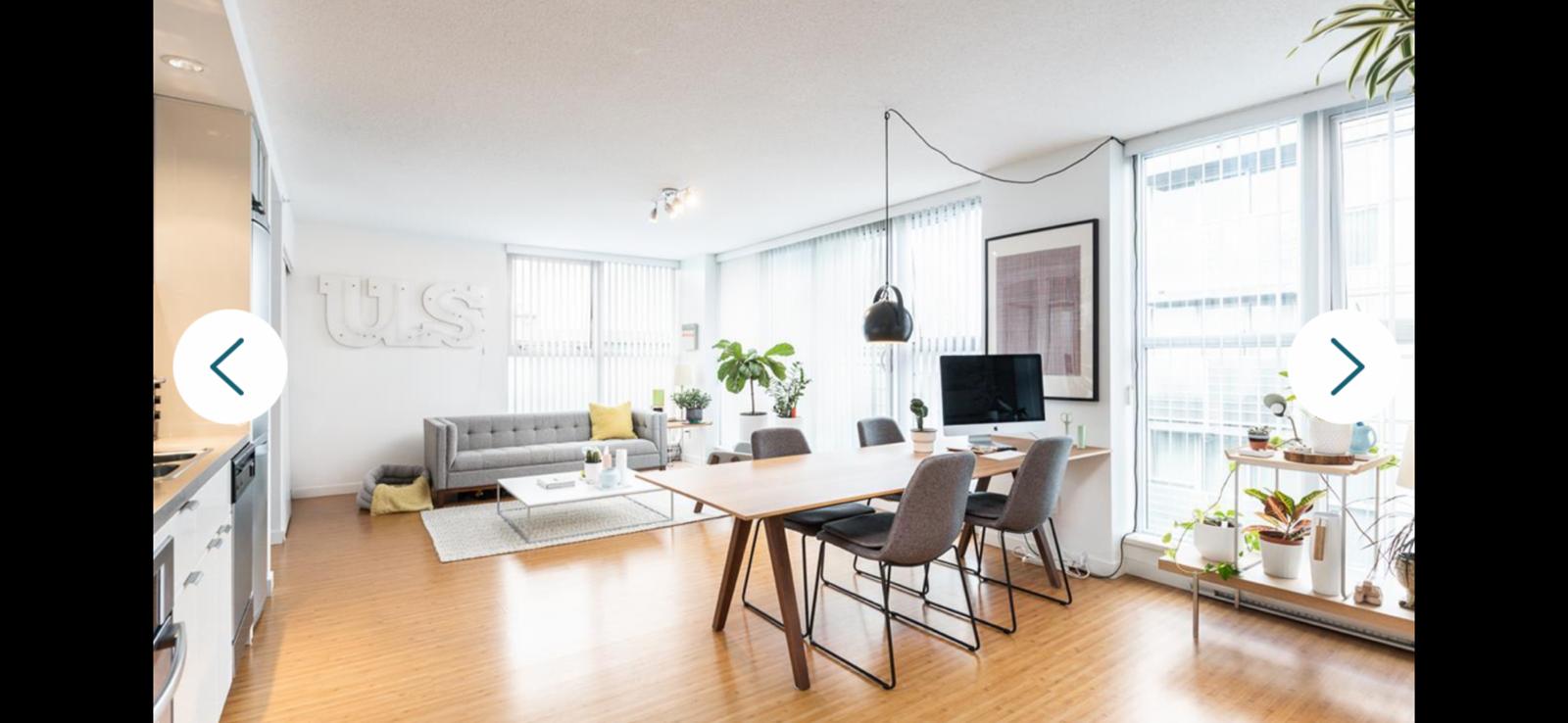 Bright and spacious Vancouver apartment living room with large windows, contemporary furniture, and natural light.