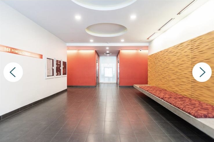 Contemporary office lobby in Vancouver with sleek design, orange accent walls, and comfortable seating area, representing Orca Realty Inc.