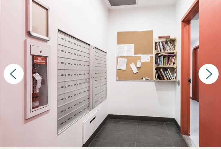 Mailboxes and bulletin board in a Vancouver apartment building lobby, showcasing secure mail storage and community notices.