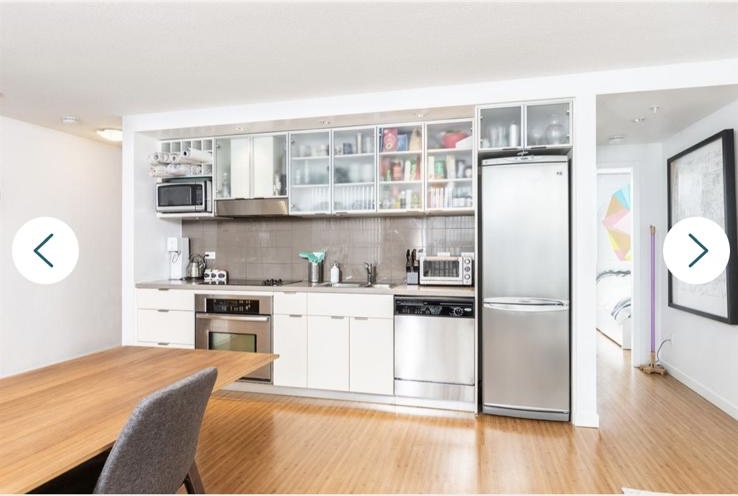 Contemporary kitchen in Vancouver with stainless steel appliances, white cabinets, and open layout, ideal for modern living.
